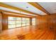 Spacious living room boasting hardwood floors, wood trim, and large windows at 7575 Holliday W Dr, Indianapolis, IN 46260
