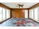 A sunroom with wood paneling, unique flooring, and many windows for natural light at 7575 Holliday W Dr, Indianapolis, IN 46260