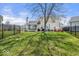 Spacious fenced-in backyard with lush green lawn, patio, and mature trees at 7914 Cardinal E Cv, Indianapolis, IN 46256
