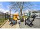 Backyard featuring a fire pit, outdoor seating, and a wooden playhouse, all enclosed by a wrought iron fence at 7914 Cardinal E Cv, Indianapolis, IN 46256