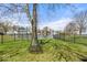 Large backyard with mature tree with a swing, lush green grass and pond at 7914 Cardinal E Cv, Indianapolis, IN 46256