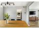 Dining area with light wood table, black chairs, modern light fixture and view to living room at 7914 Cardinal E Cv, Indianapolis, IN 46256