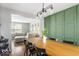 Open-concept dining area featuring a wooden table, stylish chairs, and modern lighting fixture at 7914 Cardinal E Cv, Indianapolis, IN 46256