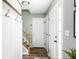Hallway view featuring modern decor elements and neutral color palette, with the staircase nearby at 7914 Cardinal E Cv, Indianapolis, IN 46256