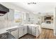 Bright kitchen with white countertops, gray cabinets, stainless steel appliances and view to Gathering room at 7914 Cardinal E Cv, Indianapolis, IN 46256