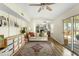 Bright living room with neutral sofa, wood floors and shelving with a kitchen view at 7914 Cardinal E Cv, Indianapolis, IN 46256