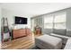 Bright living room featuring a modern media center and comfortable gray sofa at 7914 Cardinal E Cv, Indianapolis, IN 46256