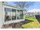 Bright sunroom with glass windows and a view of the well-maintained yard and pond at 7914 Cardinal E Cv, Indianapolis, IN 46256