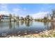 Peaceful water view with homes nestled along the shoreline and a serene sky reflected in the water at 7914 Cardinal E Cv, Indianapolis, IN 46256