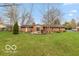 Large backyard with a well-maintained lawn and mature trees surrounding the property, offering privacy at 7915 Allisonville Rd, Indianapolis, IN 46250