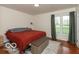 Cozy bedroom featuring a comfortable bed, natural light and a side table for storage at 7915 Allisonville Rd, Indianapolis, IN 46250
