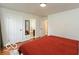 Bright bedroom featuring neutral walls and a comfortable bed with a red comforter at 7915 Allisonville Rd, Indianapolis, IN 46250