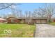 Charming brick home with a well-manicured front yard and long driveway at 7915 Allisonville Rd, Indianapolis, IN 46250