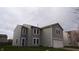 Two-story home with light-gray siding, white trim, blue front door, and an attached garage at 796 Hickory Pine Dr, Whiteland, IN 46184