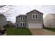 Charming two-story home with a two-car garage, green lawn, and light-gray siding at 796 Hickory Pine Dr, Whiteland, IN 46184