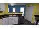 Kitchen with white cabinets and modern appliances adjacent to dining area at 796 Hickory Pine Dr, Whiteland, IN 46184