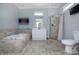 Luxurious bathroom featuring a soaking tub, walk-in shower, and modern vanity at 804 N California St, Indianapolis, IN 46202