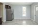 Spacious eat-in kitchen with stainless steel refrigerator, gray walls and tile floors at 804 N California St, Indianapolis, IN 46202