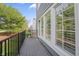 Balcony with black metal railing and views of nearby greenery and adjacent residential units at 9769 Marina Village Dr, Indianapolis, IN 46256