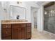 Bathroom featuring dark wood vanity, marble countertop, a rectangular mirror and tiled floor at 9769 Marina Village Dr, Indianapolis, IN 46256
