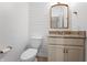 Stylish bathroom featuring granite countertops, white cabinets, and wood plank accent wall at 9769 Marina Village Dr, Indianapolis, IN 46256