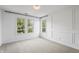 Bright bedroom with three windows, neutral carpet, decorative molding and modern light fixture at 9769 Marina Village Dr, Indianapolis, IN 46256