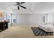 Spacious bedroom with vaulted ceiling, ceiling fan, and ample natural light from surrounding windows at 9769 Marina Village Dr, Indianapolis, IN 46256