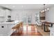 Open-concept design with counter seating, dining table with four chairs, and hardwood flooring at 9769 Marina Village Dr, Indianapolis, IN 46256