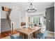 Open-concept living space with dining area, stairs, fireplace, and comfortable seating at 9769 Marina Village Dr, Indianapolis, IN 46256