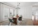 Bright dining room features decoratively paneled walls, white plantation shutters, and open floor plan at 9769 Marina Village Dr, Indianapolis, IN 46256