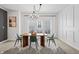 Bright dining room with modern chandelier, stylish chairs, and decorative black and white rug at 9769 Marina Village Dr, Indianapolis, IN 46256