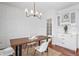 Dining room with hardwood floor, modern lighting fixture, and white wainscoting feature wall at 9769 Marina Village Dr, Indianapolis, IN 46256