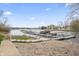 Beautiful lake view with boat docks, rock shoreline, and community walkway at 9769 Marina Village Dr, Indianapolis, IN 46256