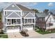 A view of the three-story home's stylish facade and attached garages and balconies at 9769 Marina Village Dr, Indianapolis, IN 46256