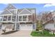 Townhouse featuring a two-car garage, charming balcony, and manicured landscaping at 9769 Marina Village Dr, Indianapolis, IN 46256