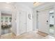 Bright foyer with a white door framed by windows and a view into the living room at 9769 Marina Village Dr, Indianapolis, IN 46256