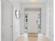 Bright foyer with a white door framed by windows, tile floor and decorative wall features at 9769 Marina Village Dr, Indianapolis, IN 46256