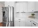 Bright kitchen features stainless steel refrigerator, white cabinets, and marble counters at 9769 Marina Village Dr, Indianapolis, IN 46256