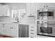 Bright kitchen features stainless steel appliances, white cabinets, and stylish fixtures at 9769 Marina Village Dr, Indianapolis, IN 46256