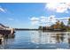 Scenic lake view with swans, waterfront homes, and lush trees reflecting in the water under a sunny sky at 9769 Marina Village Dr, Indianapolis, IN 46256