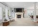 Open concept living room features a fireplace, French doors, and views to an adjacent dining room at 9769 Marina Village Dr, Indianapolis, IN 46256