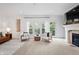 Bright living room with a fireplace, large windows, and comfortable seating at 9769 Marina Village Dr, Indianapolis, IN 46256