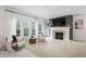 Bright living room with a fireplace, large windows, and comfortable seating at 9769 Marina Village Dr, Indianapolis, IN 46256
