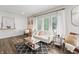 Open concept living room with hardwood floors, neutral paint, and large windows with white curtains at 9769 Marina Village Dr, Indianapolis, IN 46256