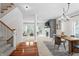 Open-concept living space featuring a staircase, fireplace, dining area, and comfortable seating at 9769 Marina Village Dr, Indianapolis, IN 46256