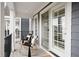 Cozy outdoor patio featuring stylish rocking chairs, a modern table, and sliding glass doors at 9769 Marina Village Dr, Indianapolis, IN 46256