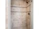 Tiled shower with decorative accent strip, showerhead, and built in bench at 9769 Marina Village Dr, Indianapolis, IN 46256