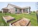 View of the backyard with raised garden beds, metal fencing, and a screened in back porch at 9831 N Port Dr, McCordsville, IN 46055