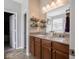 A view of the vanity with double sinks, wood cabinets and decorative shelving at 9831 N Port Dr, McCordsville, IN 46055