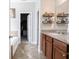 Bathroom view with granite counters, wood cabinets, tiled flooring, and a view to the closet at 9831 N Port Dr, McCordsville, IN 46055